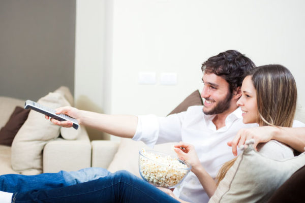 27647565 - young couple preparing to watch a movie